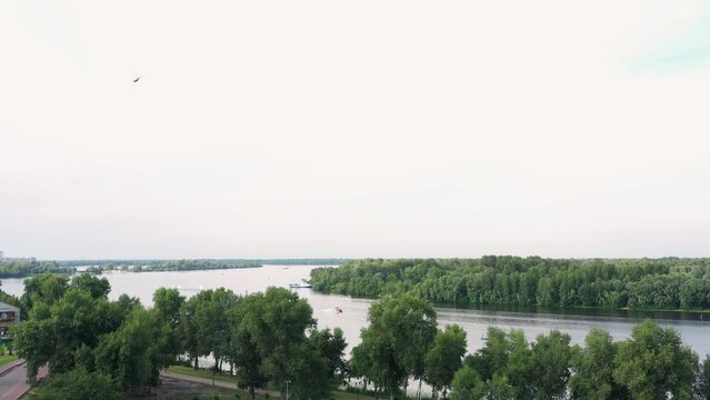 Panoramic view of the Dnieper river in the summer. Grey cloudy sky.