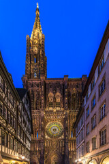 Strasbourg, France - June 19, 2023: Strasbourg Cathedral seen at night from the Rue Merciere, a pedestrian-only narrow street leading to the cathedral square.