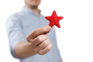 Male hand holding a red small star, cut out