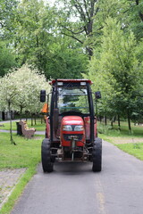 Red tractor on a road.