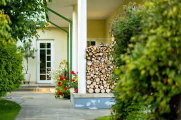 Dry chopped firewood logs stacked up on top of each other in a pile.