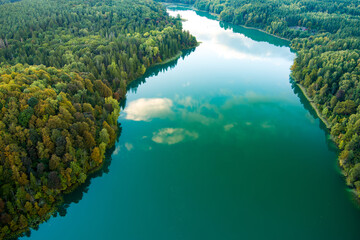 Aerial view of beautiful Balsys lake, one of six Green Lakes, located in Verkiai Regional Park. Birds eye view of scenic emerald lake surrounded by pine forests. Vilnius, Lithuania.