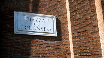 Marble street plaque with the inscription in Italian Piazza del Colosseo seen from below