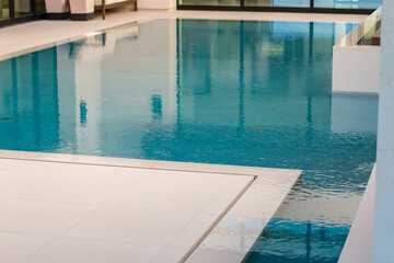 Beautiful high-end custom swimming pool overlooking a golf course with an infinity edge pool feature.