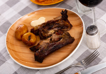 Beautiful serving of grilled pork ribs with baked potatoes