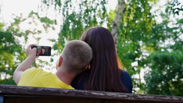 Teenagers take selfies with smartphone in outdoors. Technology with phone for photo. Child, brother, sister, friends take selfies on smartphones mobile devices. Concept modern technologies. Children