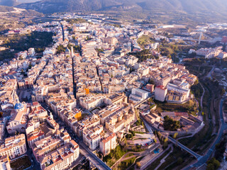 View from drone of residential areas of Spanish town of Alcoy with Iglesia arciprestal de Santa Maria