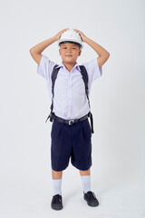 A young Asian cute boy standing in a Thai school uniform with a backpack bag and safety helmet  on a white background banner