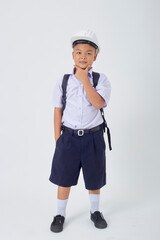 A young Asian cute boy standing in a Thai school uniform with a backpack bag and safety helmet  on a white background banner