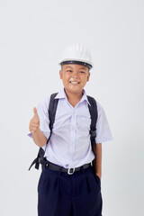 A young Asian cute boy standing in a Thai school uniform with a backpack bag and safety helmet  on a white background banner