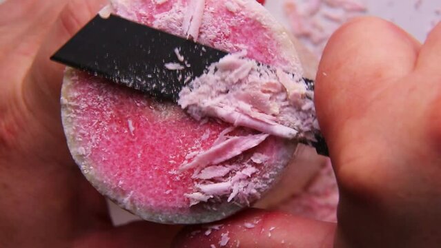 ASMR-video with sound cutting paraffin with a knife into pieces. 