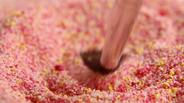  The multicolored powder is kneaded with a brush. Macro. ASM video.