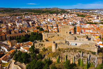 Fototapeta na wymiar View from drone of historic center of Spanish city of Almansa overlooking ancient fortified Castle and bell-tower of Roman Catholic Church, province of Albacete