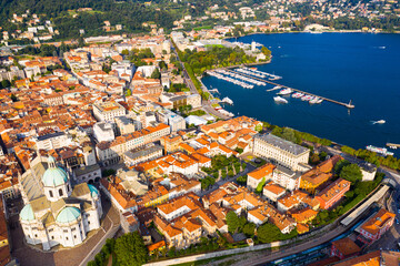 Fototapeta na wymiar Spectacular view of Italian city of Como at foot of mountain on shore of Lake Como