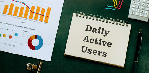 There is notebook with the word Daily Active Users. It is as an eye-catching image.