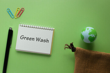 There is notebook with the word Green Wash. It is as an eye-catching image.