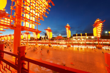 Chinese lanterns by the river in winter，Chinese festive lantern at night