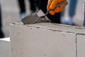 The bricklayer is working. Building a wall of aerated concrete. Gasbeton wall