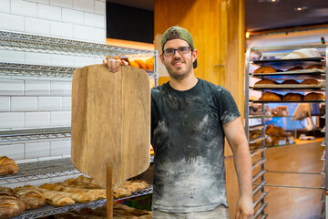 Portrait of baker of bakery in workshop workshop of artisan bakery with shovel