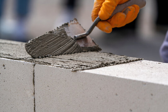 The bricklayer is working. Building a wall of aerated concrete. Gasbeton wall