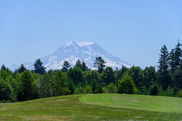 Scenic tee box on a public golf course, Mount Rainier in the background, recreation on a sunny summer day
