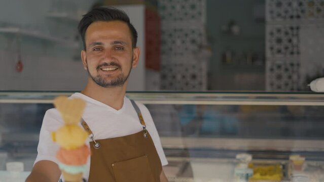ice cream shop owner holding ice cream