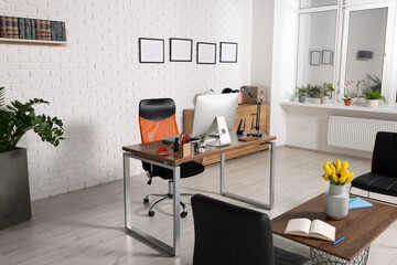 Stylish director's workplace with comfortable furniture and waiting area in office. Interior design