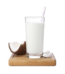 Glass of delicious vegan milk near coconut pieces on white background