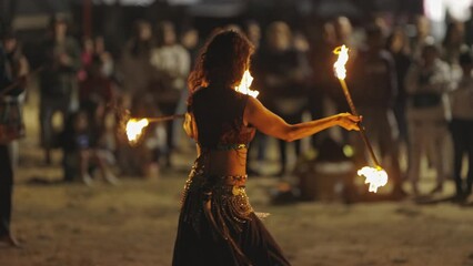 A woman performing a fire show at the street