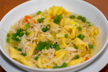 Traditional chicken agnolini (capeletti) soup. winter soup