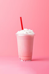 Strawberry milkshake in plastic takeaway cup isolated on pink background