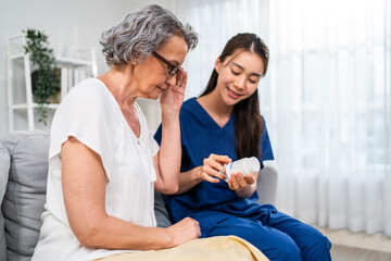 Asian caregiver nurse give consult to Caucasian senior woman patient. 