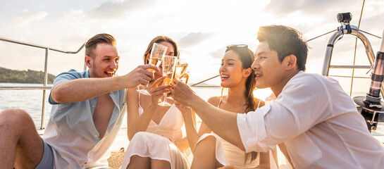 Group of diverse friends drink champagne while having a party in yacht. 