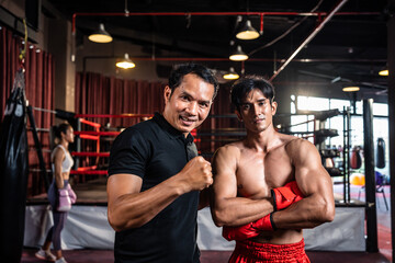 Portrait of Asian male referee and sportsman boxer in boxing stadium. 