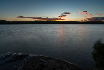 a lake sunset with fuzzy looking water 