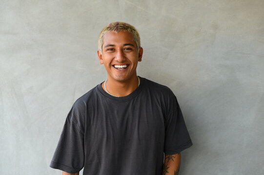 Cheerful young hipster man smiling and looking at camera