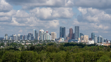 Fototapeta na wymiar Calgary city skyline view from a hill. Calgary, Alberta, Canada - July 4, 2023.