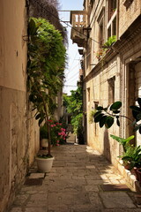 Narrow street of Korcula town in Croatia and a fragment of its architecture