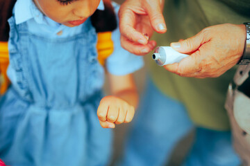 Nanny Applying Sting Relief Cream on the Hand of Little Girl. Granny treating an allergic reacting...