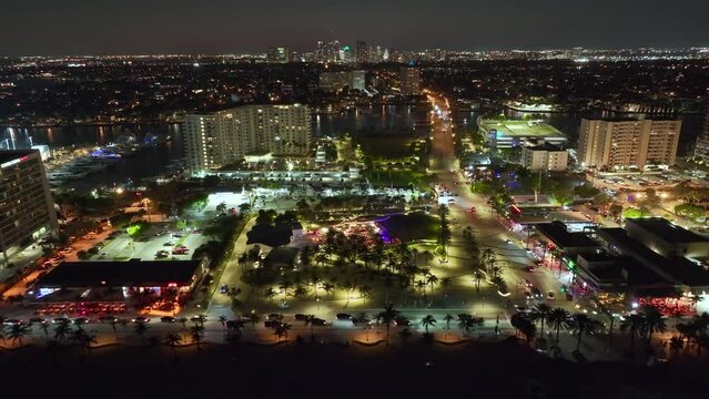 Fort Lauderdale city with brightly illuminated luxury hotels and condos at Las Olas Beach. High angle view of tourist infrastructure in southern Florida, USA