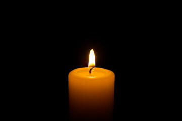 Fototapeta na wymiar Candle flame against a black background