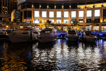 Fototapeta na wymiar boats in port at Dubai marina at night in bright lights.