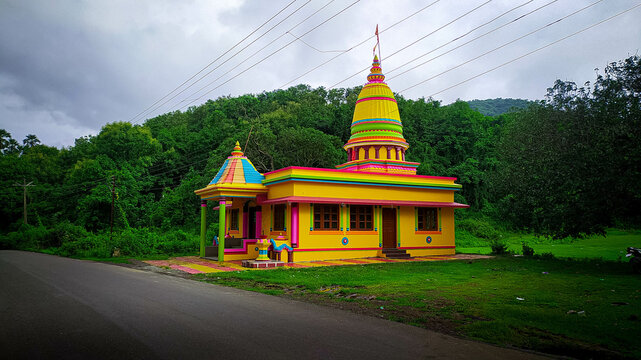 Colourful temple with green background in India.