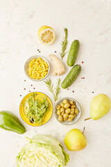 Christmas tree shaped of food. Yellow and green food colours. Low fodmap vegan diet ingredients - vegetables, fruits, greens with copy space. Keto, paleo, plant based diet concept.