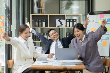 Asian business presents to explain the graph work on the whiteboard. Consulting, discussing, exchanging knowledge.