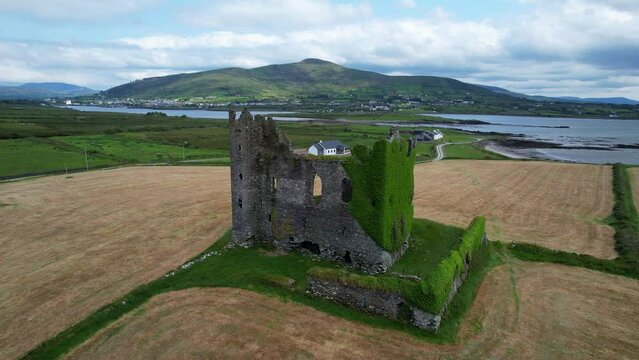 Aerial circle of ivy-covered Ballycarbery Castle near the Ocean, Cahersiveen, Ireland
