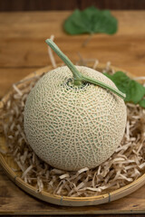 Premuim Crown Musk Melon on wooden background, Shizuoka Crown Melon Yama Grade on wooden background.