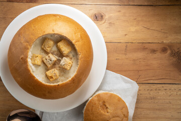 Cream Of Mushroom Soup with Bread bowl on wooden background.