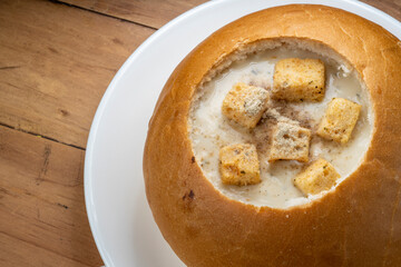 Cream Of Mushroom Soup with Bread bowl on wooden background.