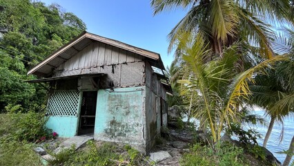 an old abandoned hut hangs on the edge of a ravine, at Samadua, South Aceh Indonesia 